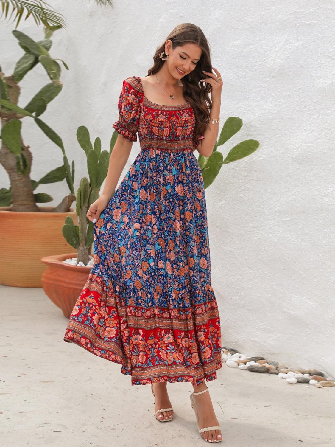 a woman in a blue and red floral print dress