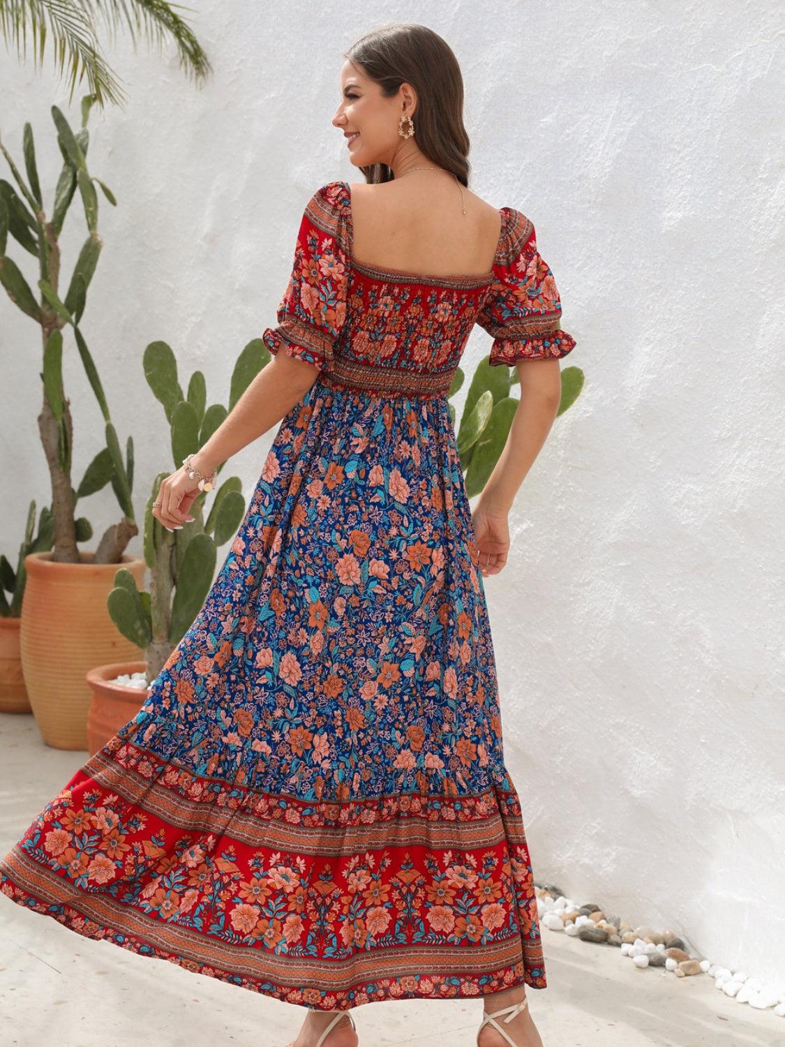 a woman in a blue and red floral print dress