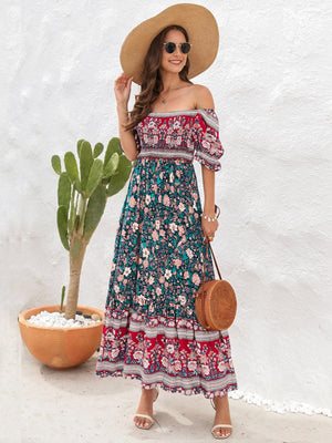 a woman in a dress and hat standing next to a potted plant