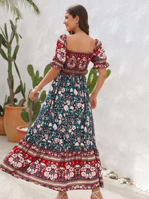 a woman in a floral print dress standing in front of a cactus