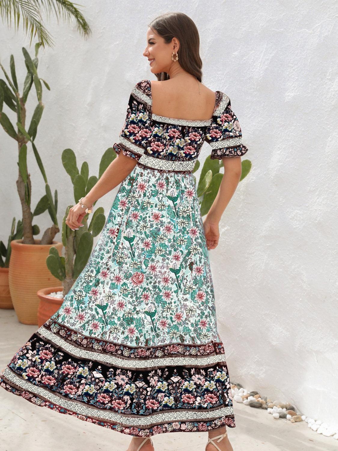 a woman in a floral print dress standing in front of a cactus