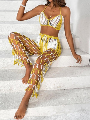 a woman in a yellow and white outfit sitting on some steps