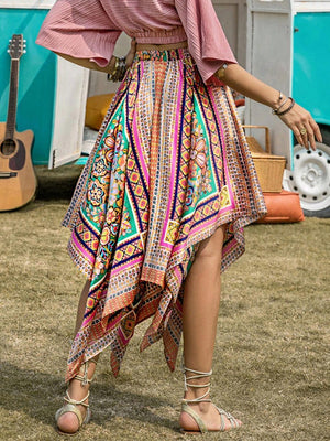 a woman wearing a skirt and a pink top