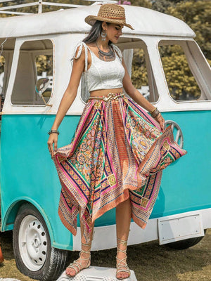 a woman in a hat and skirt standing in front of a van