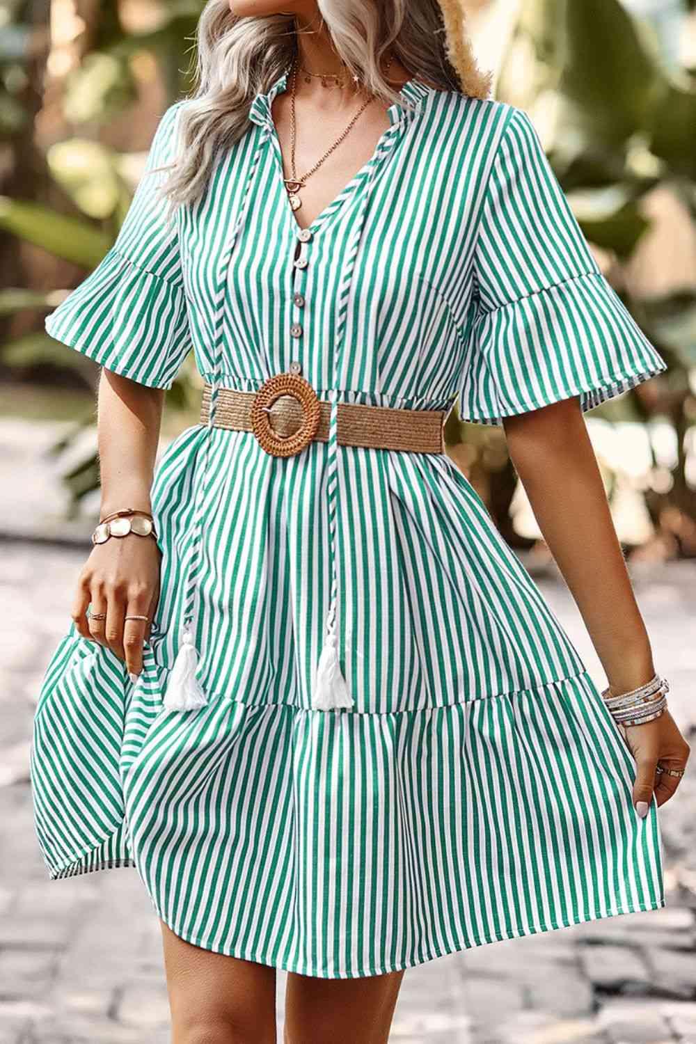 a woman wearing a green and white striped dress