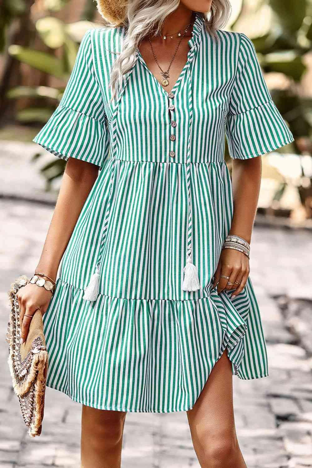 a woman wearing a green and white striped dress