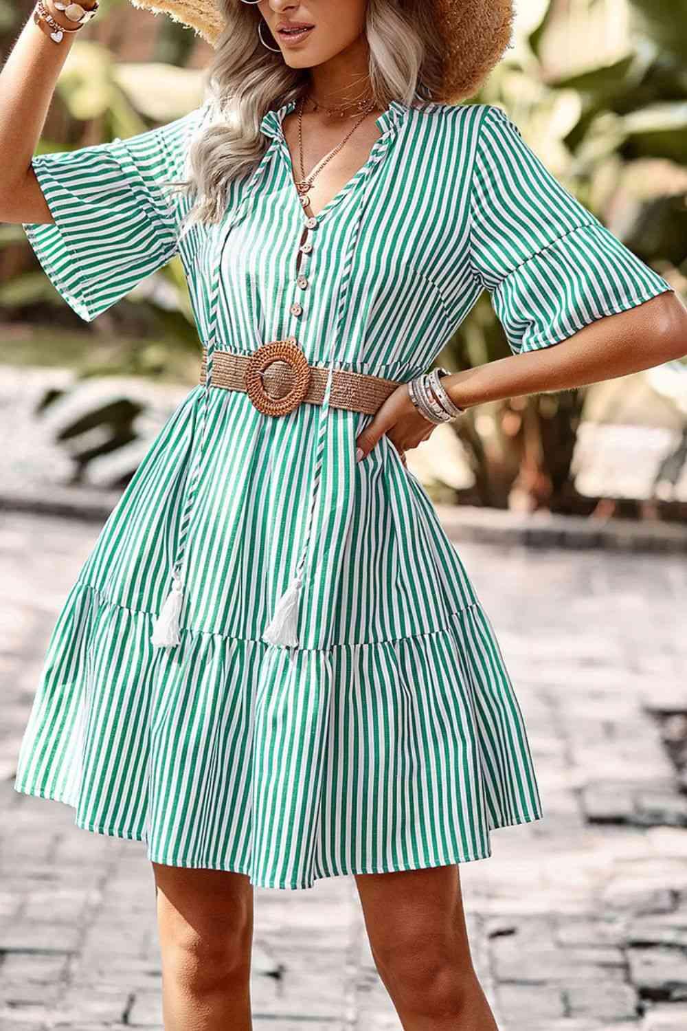 a woman wearing a green and white striped dress