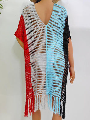 a woman wearing a crochet shawl with a red, white, and