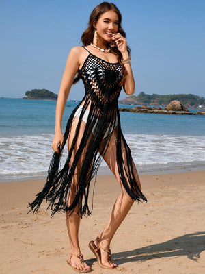 a woman standing on a beach next to the ocean