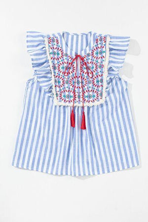 a blue and white striped top with a red tassel