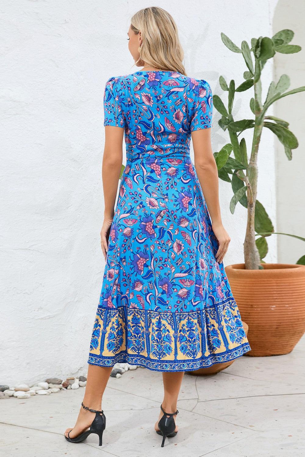 a woman in a blue dress standing next to a potted plant