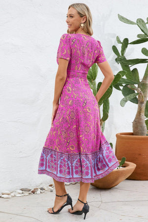 a woman standing in front of a potted plant