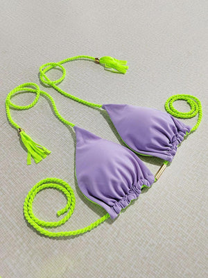 a pair of purple bikinis with a green string