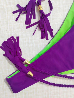 a purple and green piece of cloth with tassels
