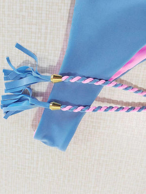 a pair of pink and blue toothbrushes sitting on top of a blue bag