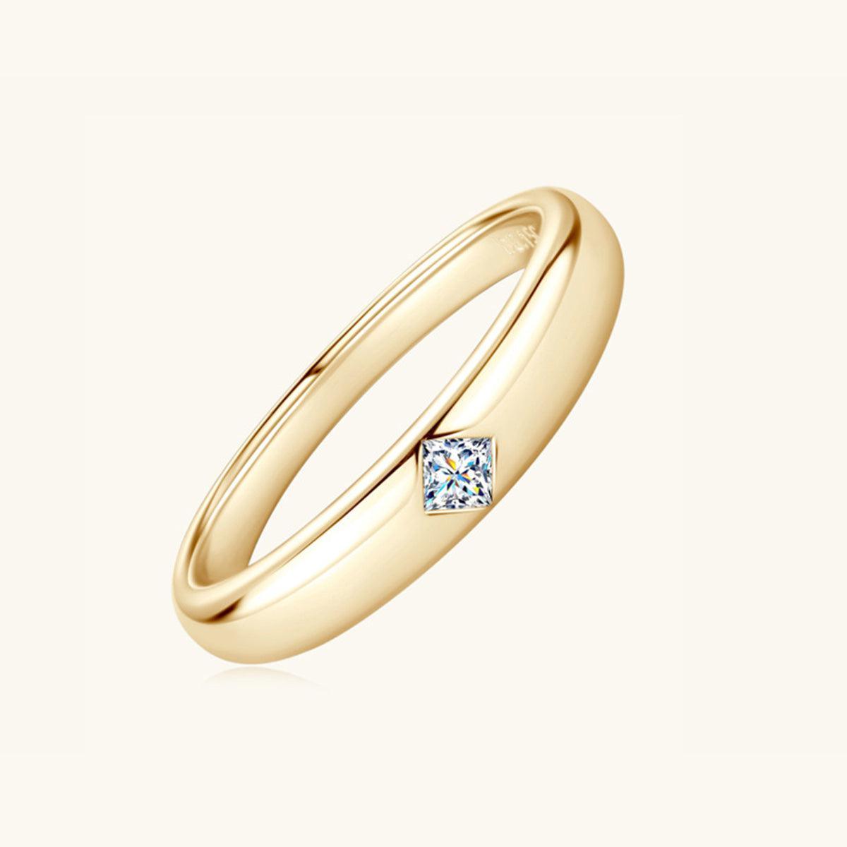 a yellow gold ring with a princess cut diamond