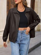 a woman wearing a black jacket and jeans