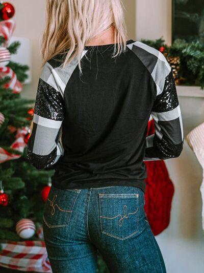 a woman standing in front of a christmas tree