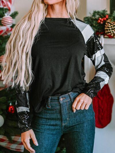 a woman standing in front of a christmas tree