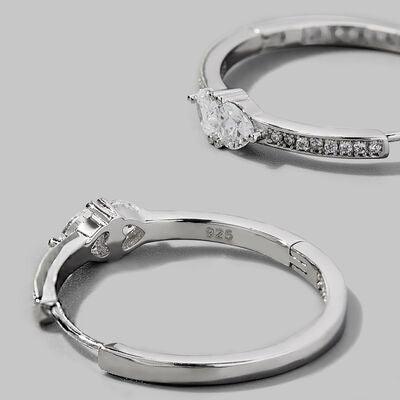 a pair of diamond engagement rings on a gray background