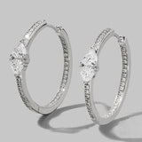 a pair of white gold and diamond hoop earrings