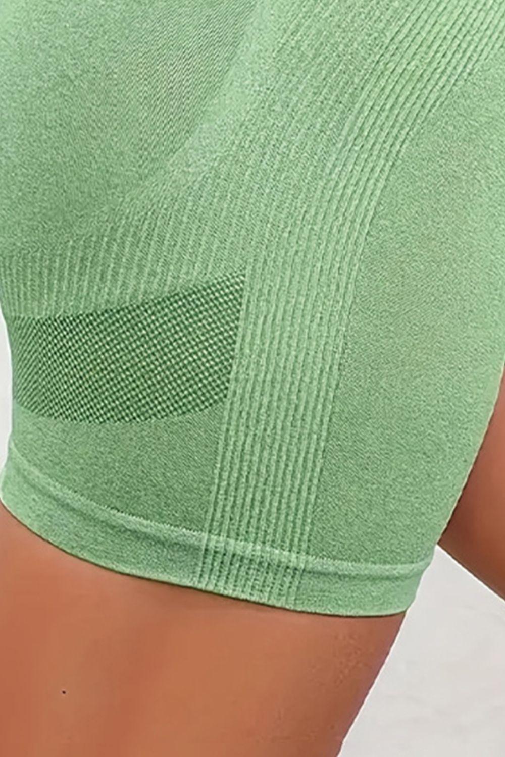 a close up of a woman's butt wearing a green sports bra