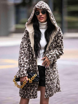 a woman wearing a leopard print coat and black shorts