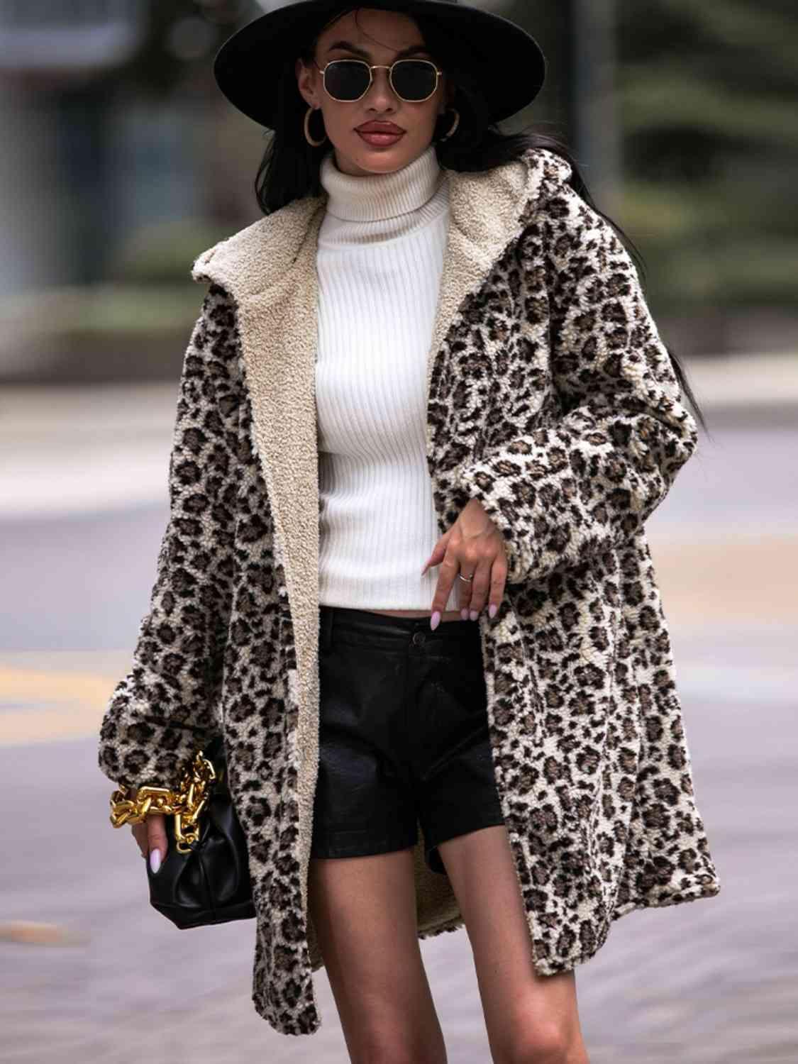 a woman in a leopard print coat and hat