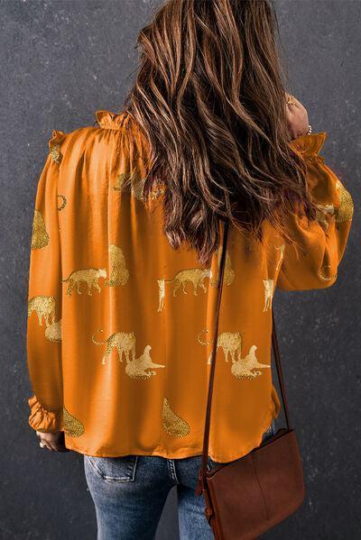 a woman with long hair wearing an orange shirt with giraffes on it