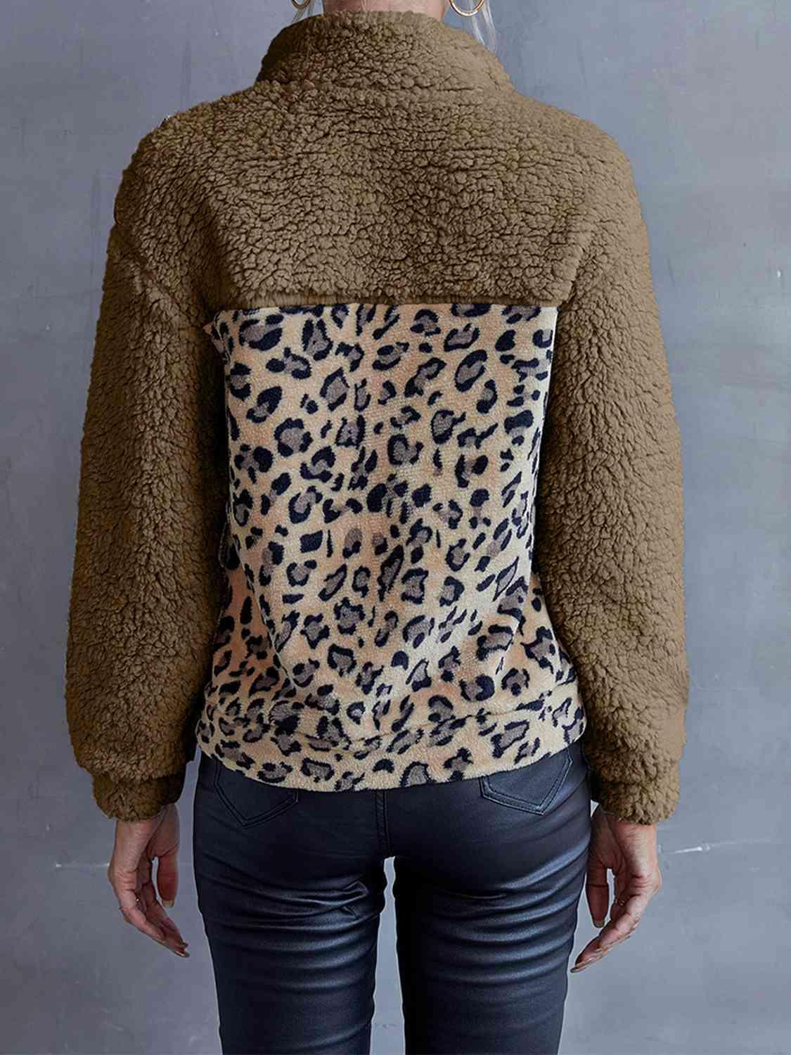 a woman wearing a jacket with a leopard print on it