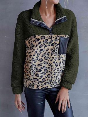 a woman wearing a green jacket with a leopard print pocket