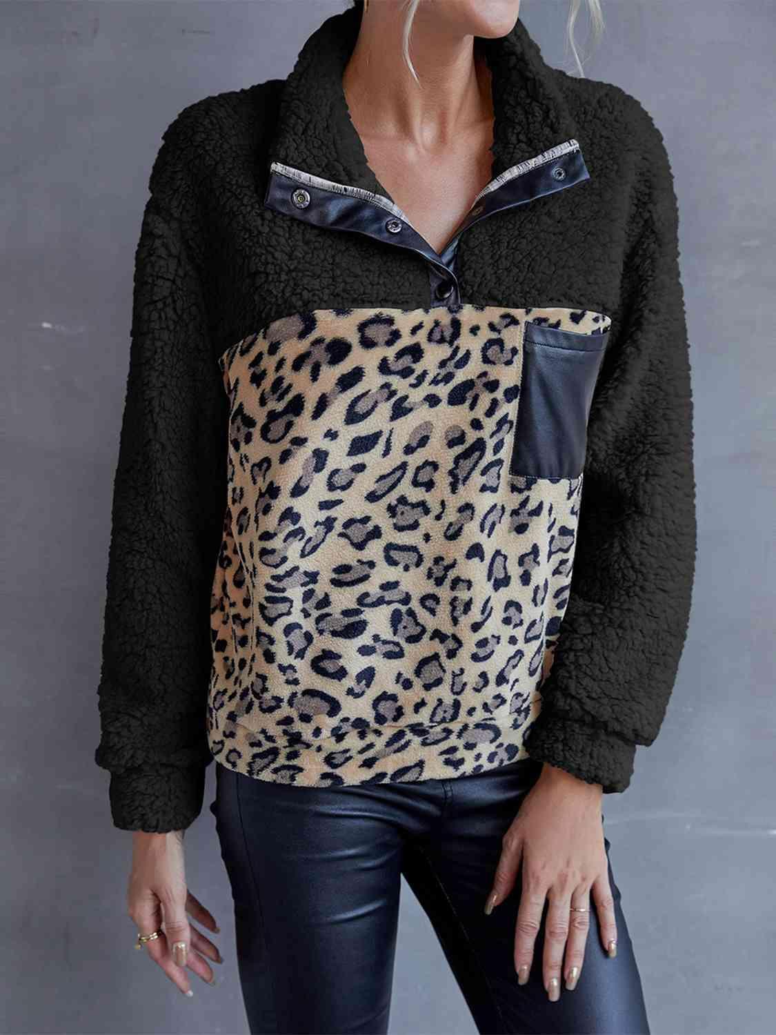 a woman wearing a jacket with a leopard print on it