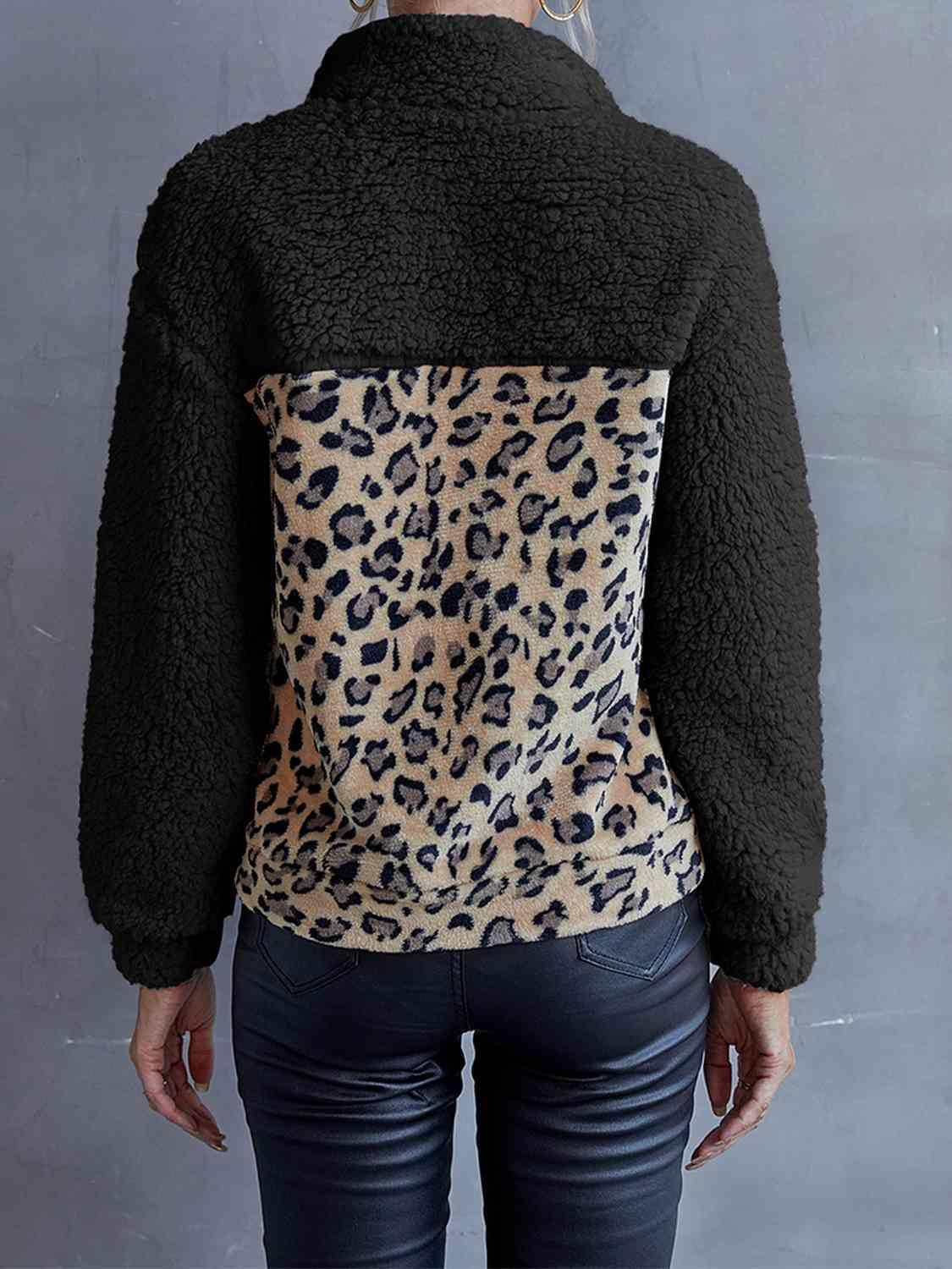 a woman wearing a jacket with a leopard print on it