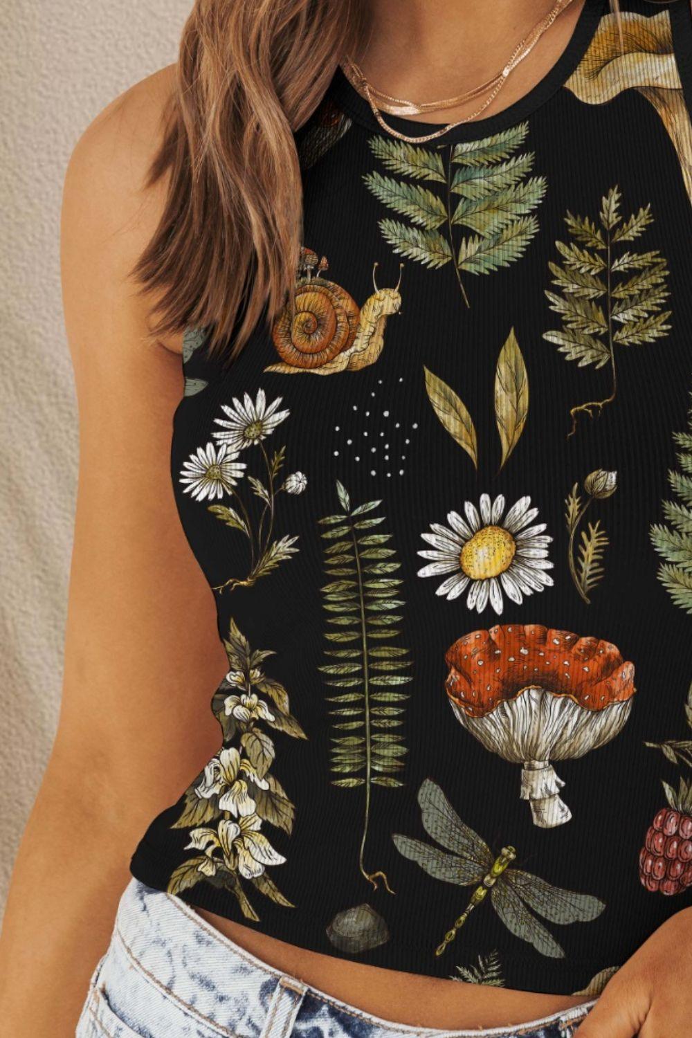 a woman wearing a black top with flowers and a snail on it