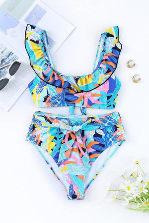 a bathing suit with a tropical print on it