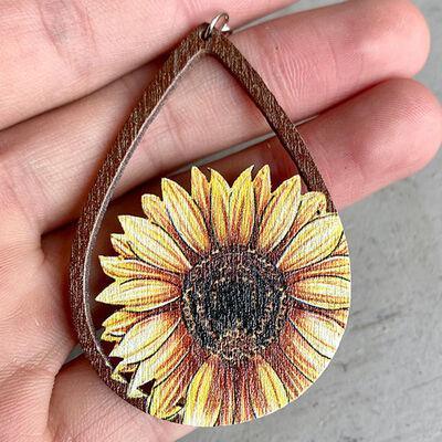 a sunflower painted on a wooden tear shaped pendant