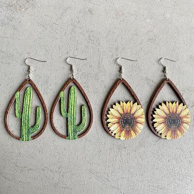 three pairs of earrings with a sunflower on them