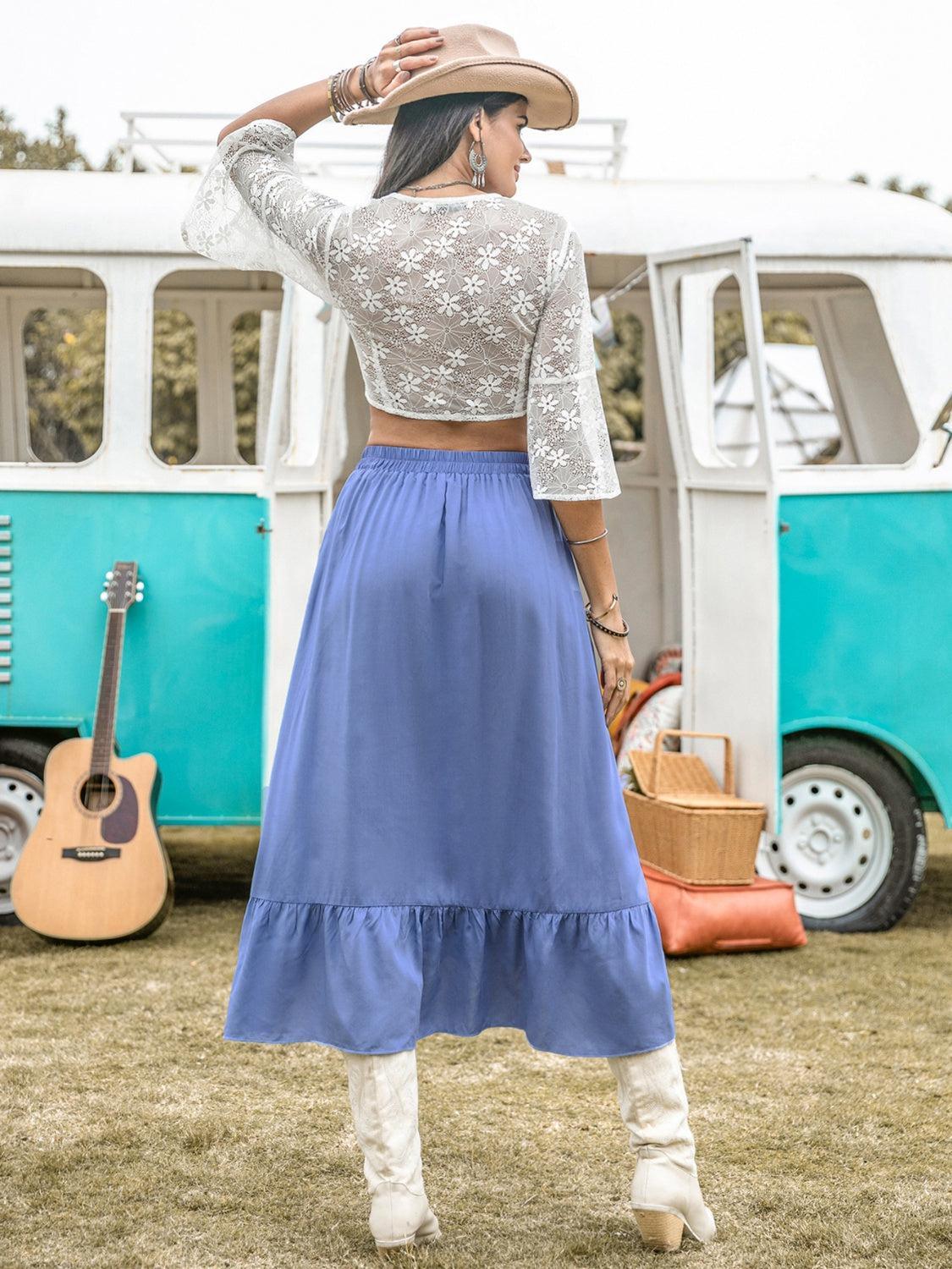 a woman wearing a blue skirt and a white top
