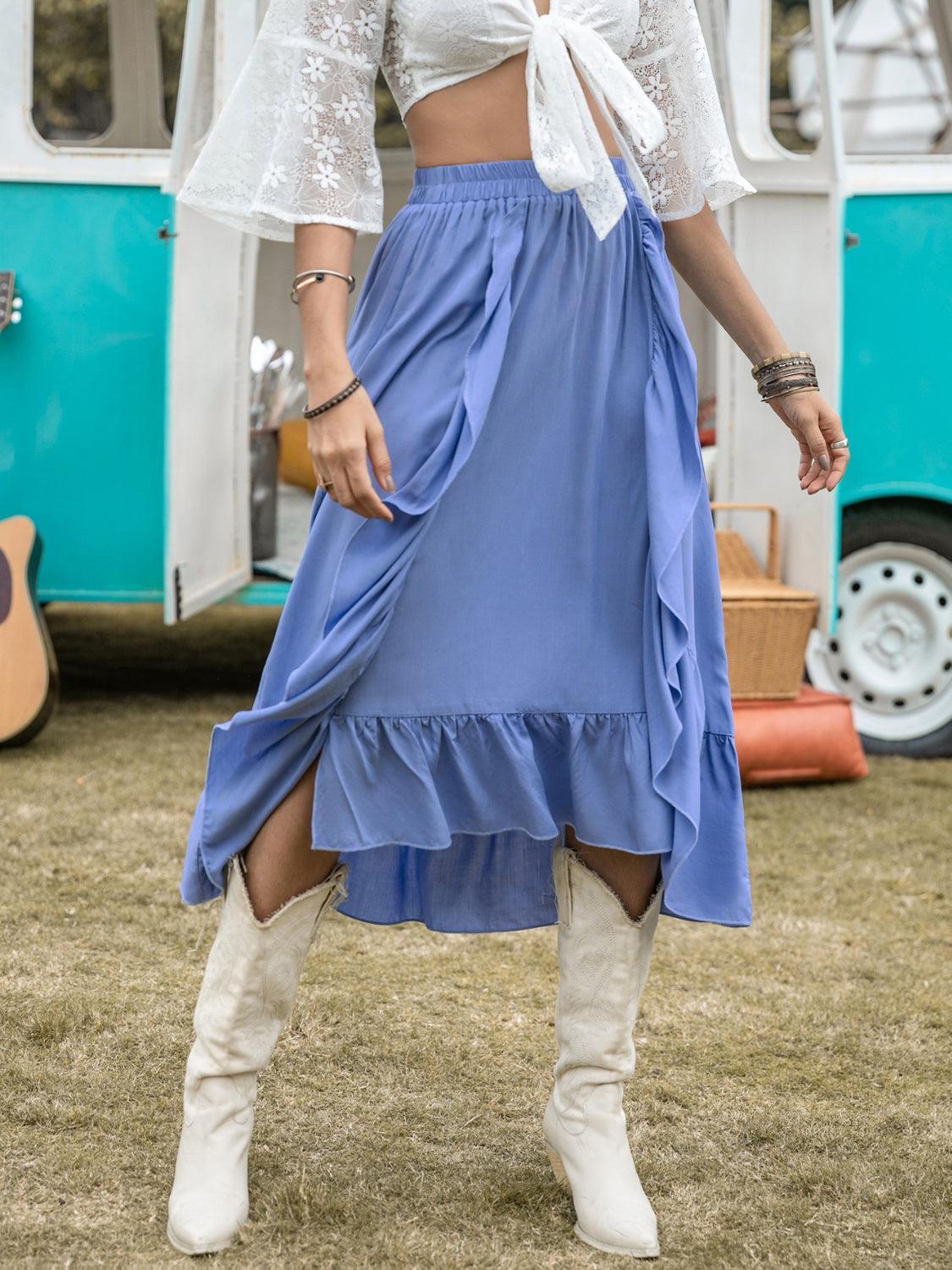 a woman in a white top and blue skirt