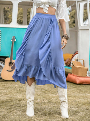 a woman in a blue skirt and white top