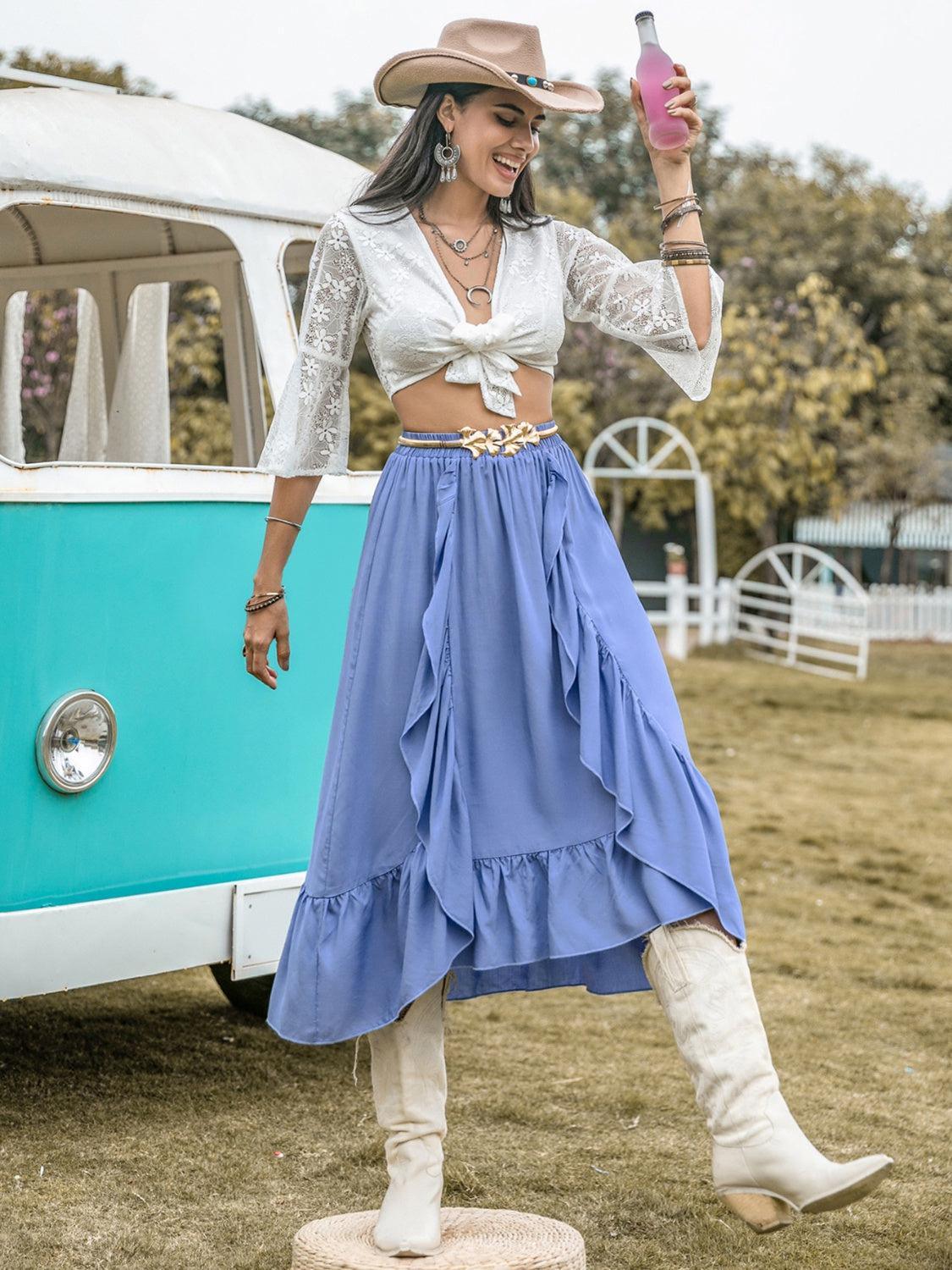 a woman in a long skirt and cowboy hat standing in front of a vw