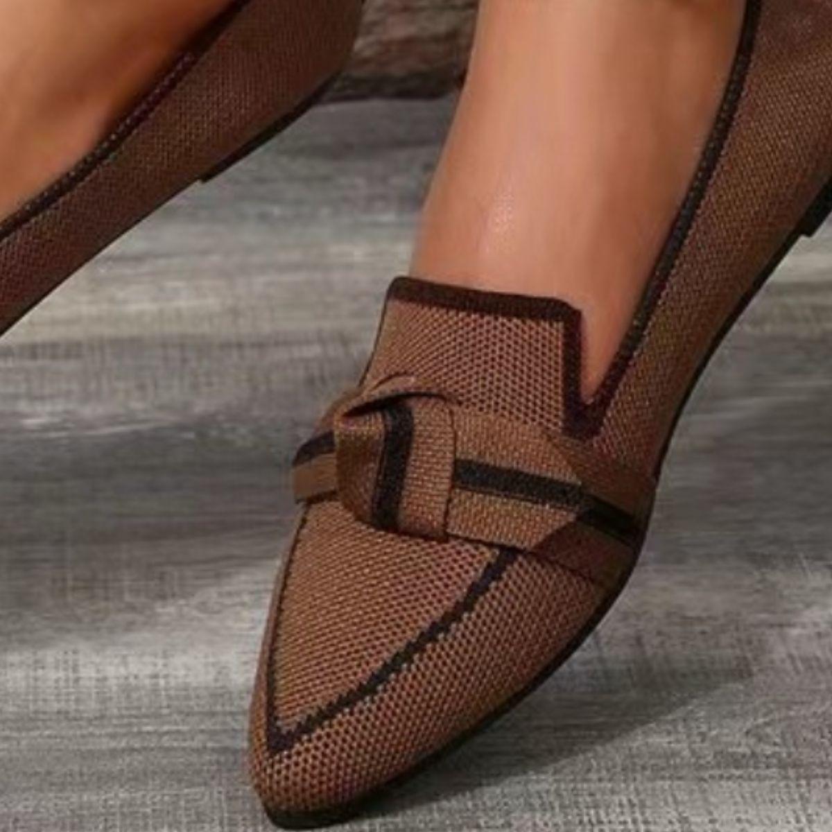 a close up of a person wearing brown shoes