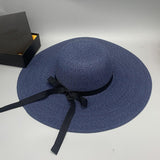 a blue hat with a black ribbon around the brim
