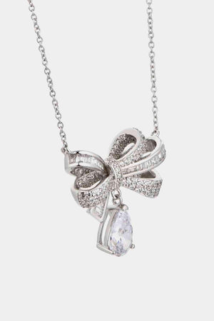 a necklace with a bow and crystal stones