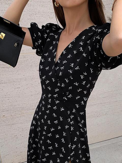 a woman in a black dress holding a black purse