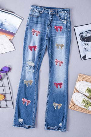 a pair of blue jeans with red and white bows on them