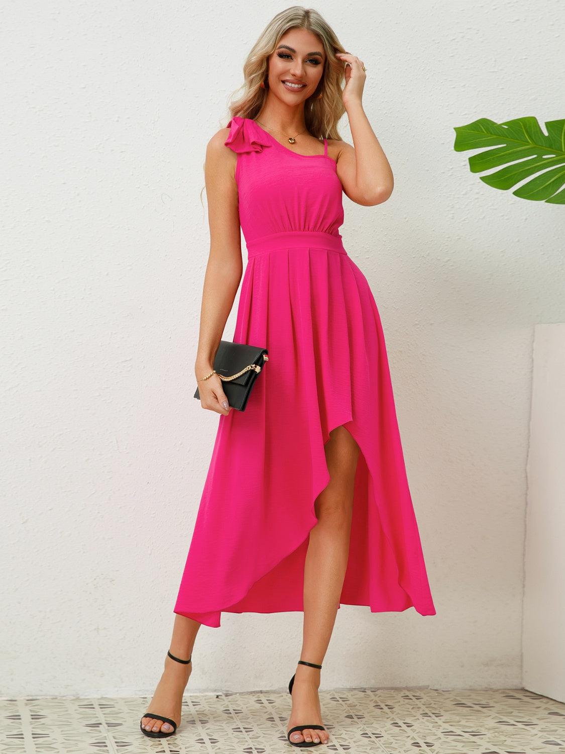 a woman in a pink dress posing for a picture