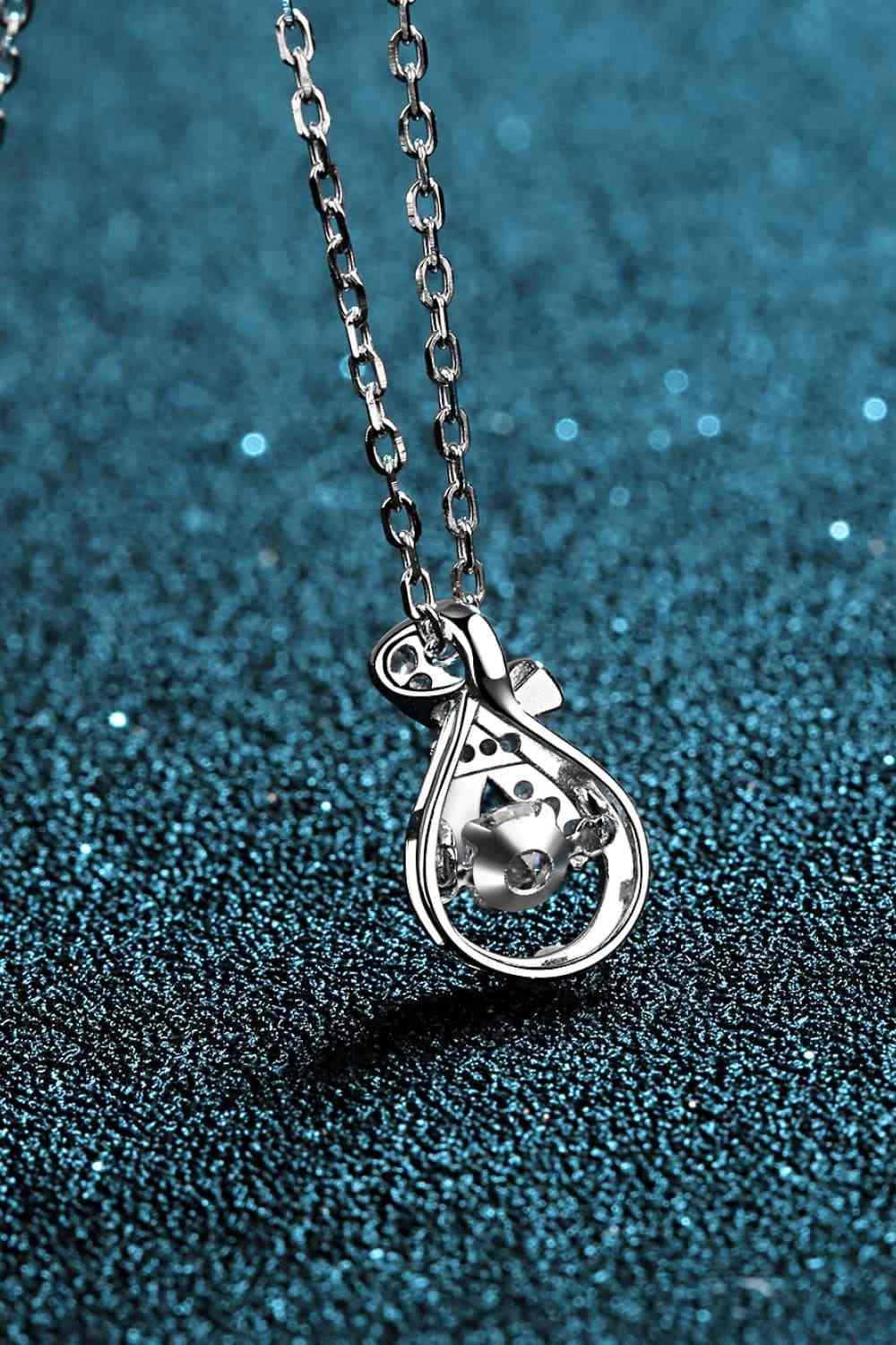 a silver necklace with a heart on it