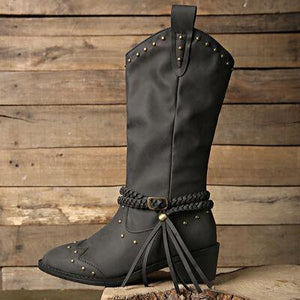 a pair of black cowboy boots with tassels