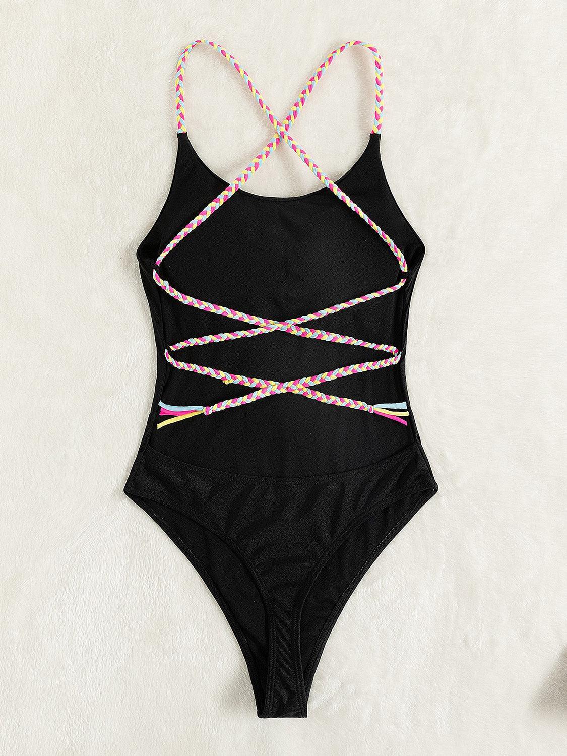 a black one piece swimsuit with pink, yellow, and blue beads